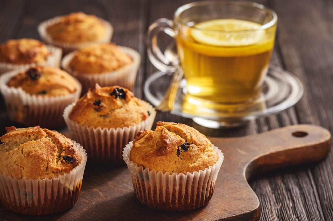 Gluten free buckwheat muffins on chopping board with herbal tea.