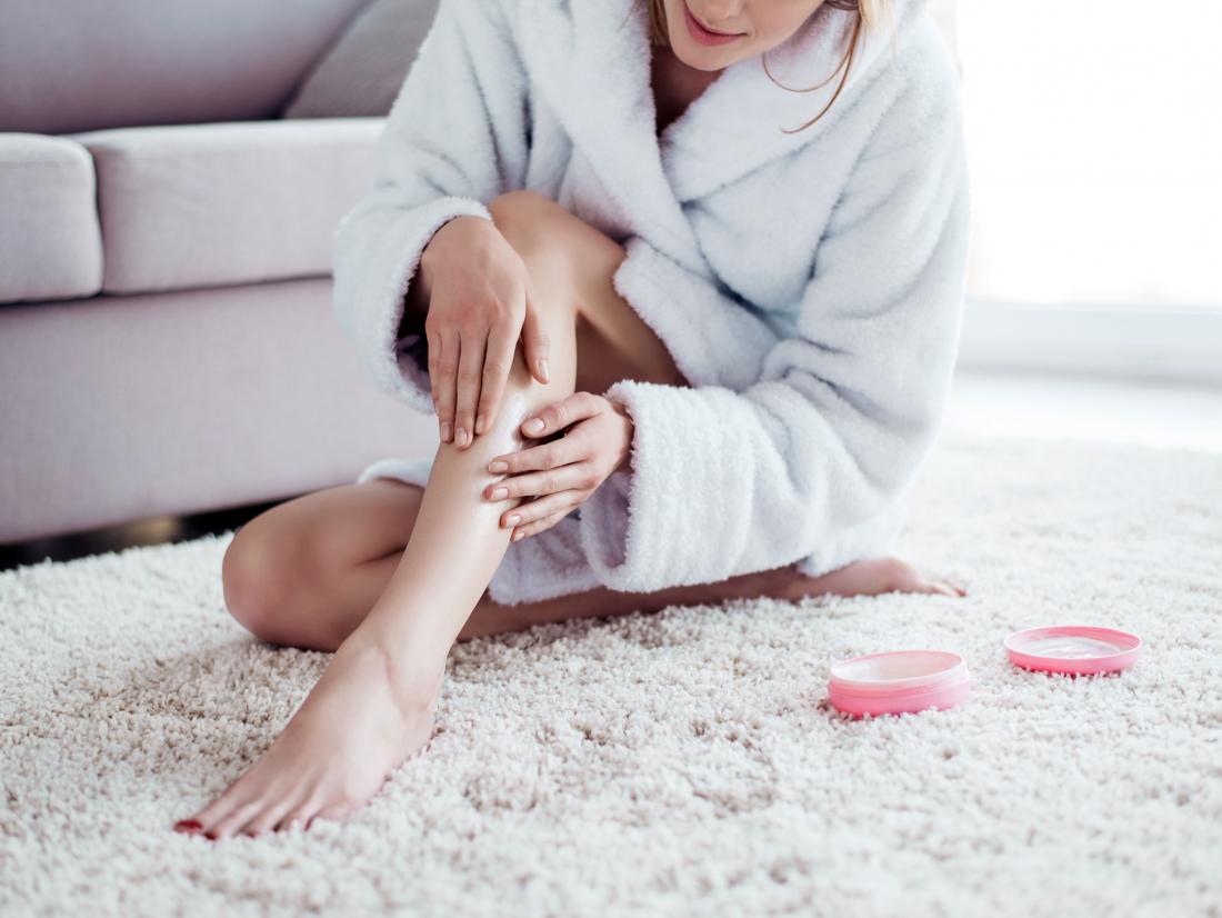 Woman applying lotion to get rid of razor bumps