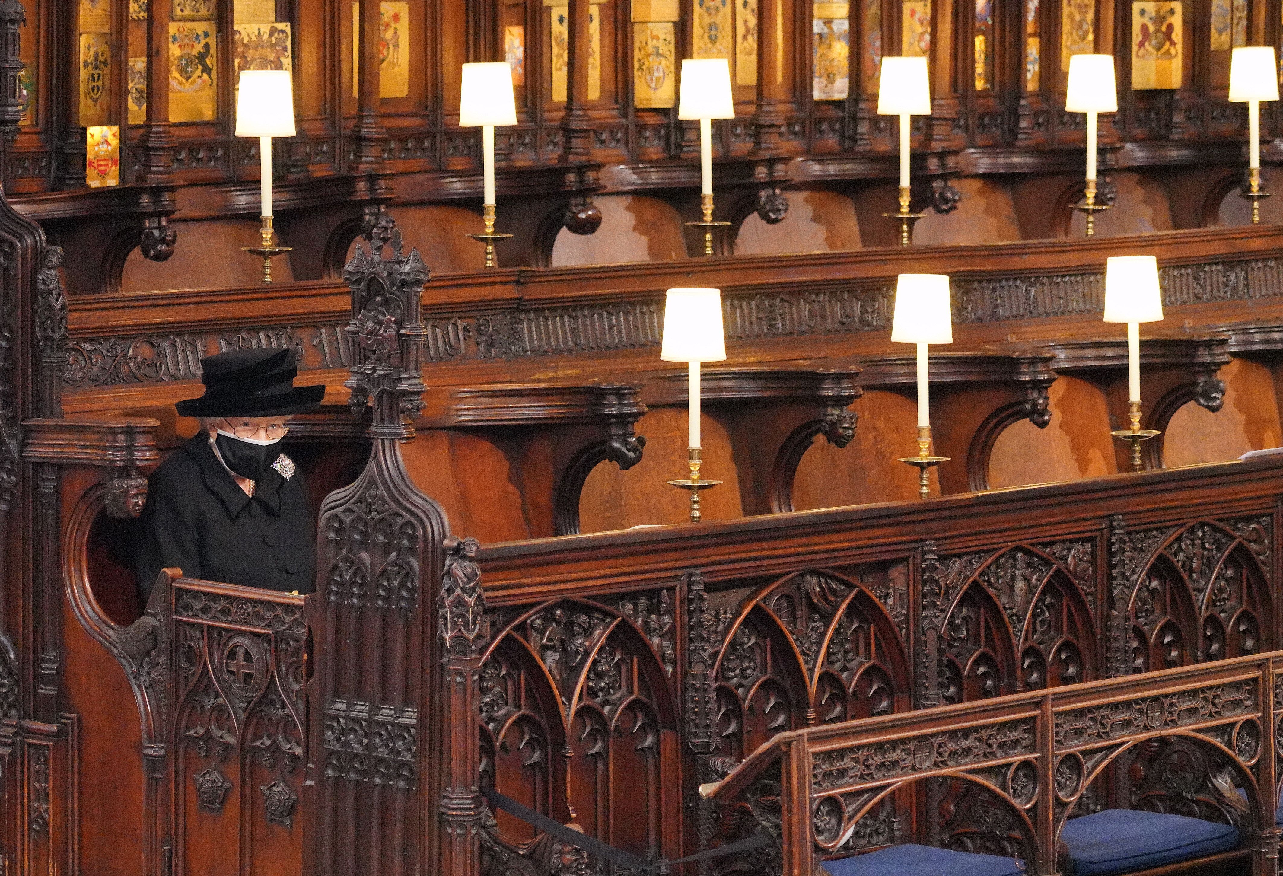 Queen Elizabeth II takes her seat during the funeral of Prince