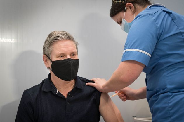 Keir Starmer receives his first dose of the AstraZeneca coronavirus vaccine from midwife, Emily Malden...