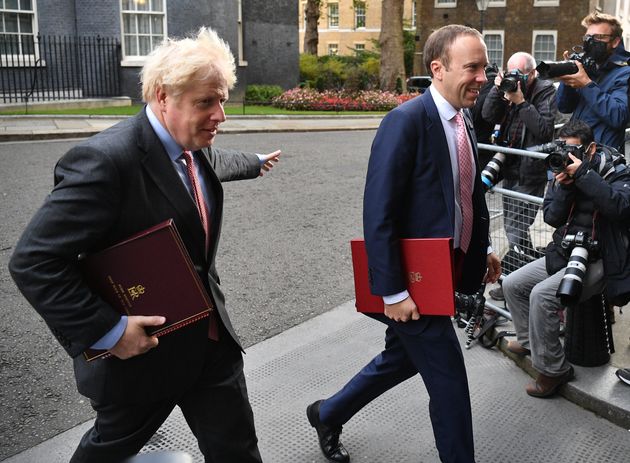 Prime Minister, Boris Johnson and Secretary of State for Health and Social Care, Matt Hancock walk from...