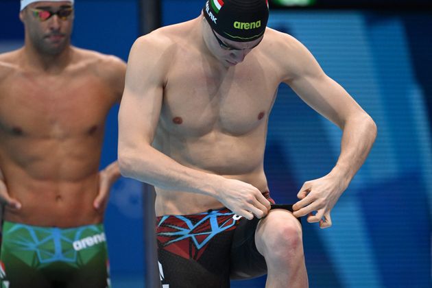 Kristof Milak adjusts his swim trunks ahead of the final of the men's 200-meter butterfly final at the...