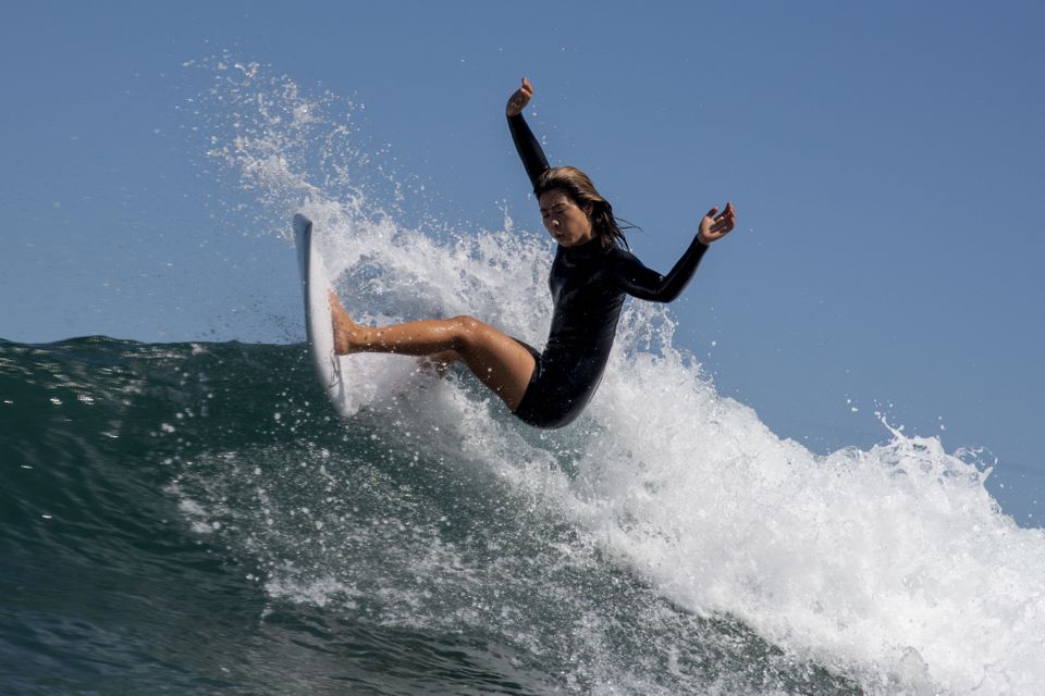 Japan's Mahina Maedagoes rides a wave during a free training session at the Tsurigasaki Surfing Beach,...