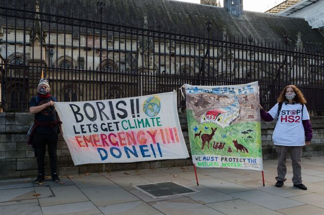 Environmental activists protest in Parliament Square against the UK's High Speed 2 railway project as...