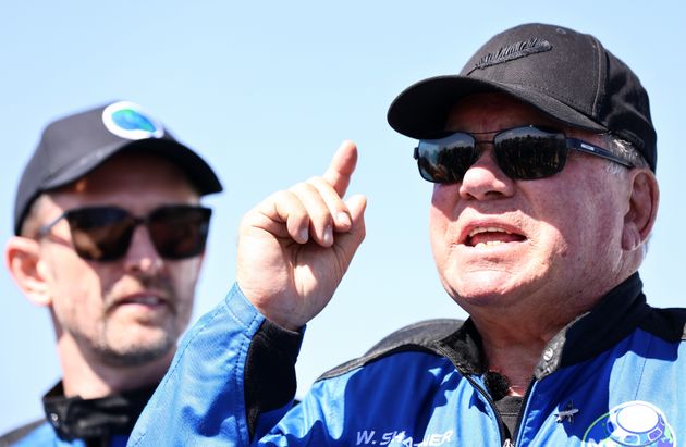 William Shatner speaks at the landing pad of Blue Origin’s New Shepard after they flew into space...