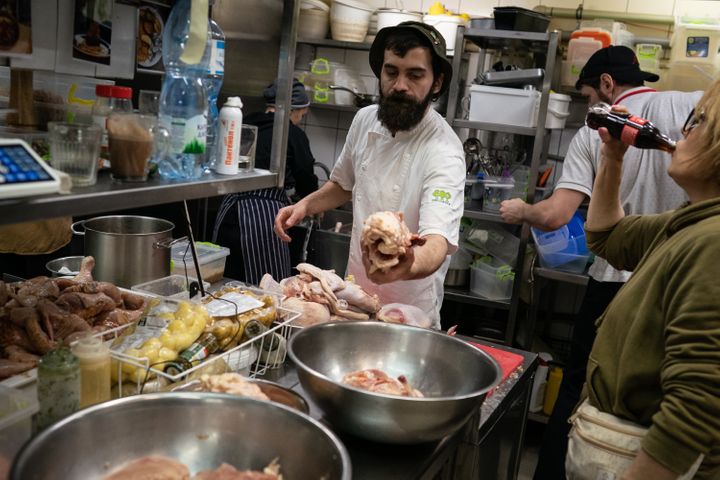 Civilians are seen in a downtown restaurant cooking food to distribute to soldiers, amid Russia's attacks.