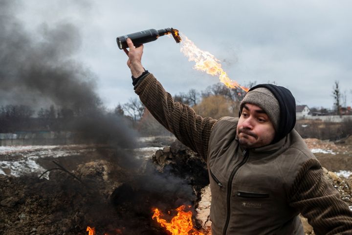 A civilian trains to throw Molotov cocktails to defend the city