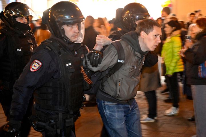 Police officers detain a man in Moscow on September 21, 2022, following calls to protest against partial mobilisation announced by President Vladimir Putin. - President Vladimir Putin called up Russian military reservists on September 21, saying his promise to use all military means in Ukraine was "no bluff," and hinting that Moscow was prepared to use nuclear weapons. His mobilisation call comes as Moscow-held regions of Ukraine prepare to hold annexation referendums this week, dramatically upping the stakes in the seven-month conflict by allowing Moscow to accuse Ukraine of attacking Russian territory. (Photo by Alexander NEMENOV / AFP) (Photo by ALEXANDER NEMENOV/AFP via Getty Images)