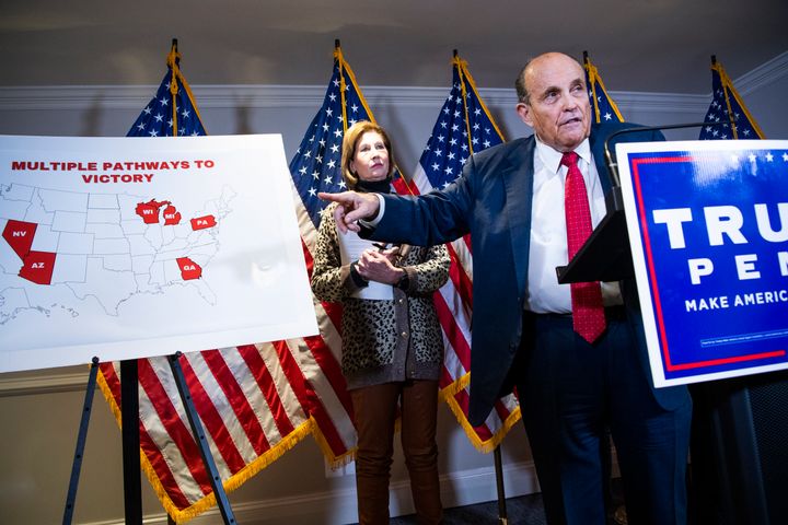 The indictment names six co-conspirators, five of whom can be identified. They include attorneys Sidney Powell (left) and Rudy Giuliani.