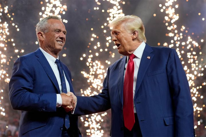 Republican presidential nominee former President Donald Trump shakes hands with Independent presidential candidate Robert F. Kennedy Jr. at a campaign rally, Friday, Aug. 23, 2024, in Arizona. (AP Photo/Evan Vucci)