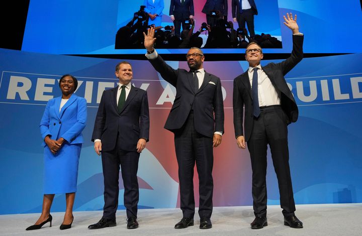 Conservative leadership candidates Kemi Badenoch, from left, Robert Jenrick, James Cleverly and Tom Tugendhat stand on the podium during the Conservative Party Conference in Birmingham. (AP Photo/Kin Cheung)