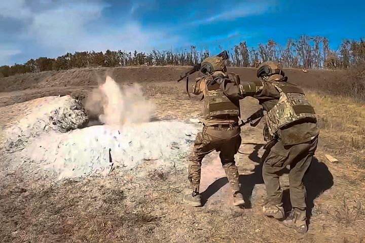 In this photo released by Russian Defence Ministry Press Service on Wednesday, Oct. 2, 2024, Russian soldiers attend combat training for assault units at an undisclosed location in Ukraine.