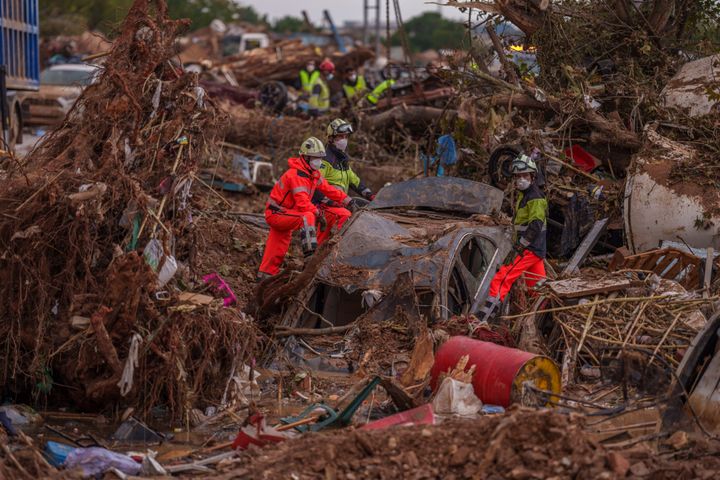 Emergency services remove cars in an area affected by floods in Catarroja, Spain, on Sunday, Nov. 3, 2024.