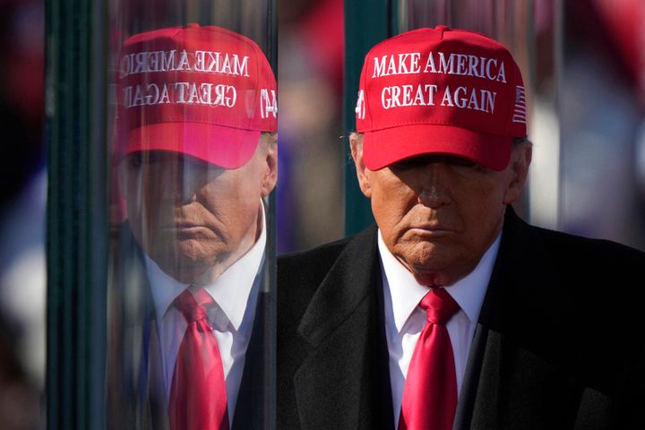 Republican presidential nominee former President Donald Trump is reflected in the bullet proof glass as he finishes speaking at a campaign rally in Lititz, Pa., Nov. 3, 2024. 